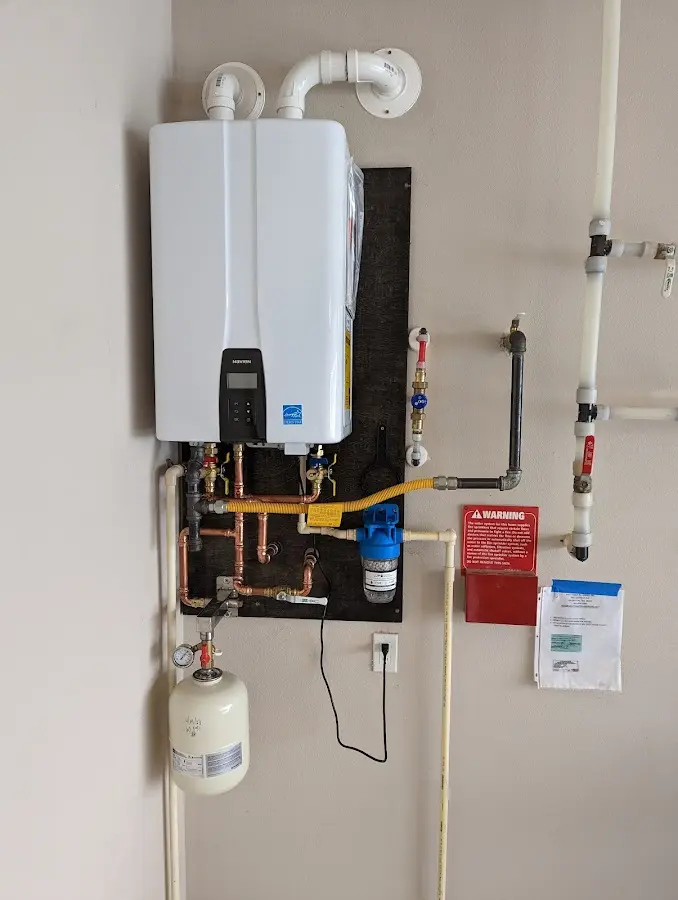 Professional plumber installing copper piping in a Fairfax home